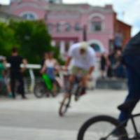 Defocused image of a lot of people with bmx bikes. Meeting of fans of extreme sports photo