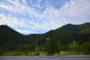 Asphalt road in the mountainous terrain in the morning photo