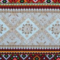 Traditional Ukrainian folk art knitted embroidery pattern on textile fabric photo