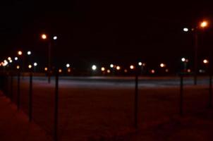 Blurred photo of school playground at night with bright lights