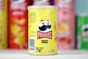 KHARKIV, UKRAINE - DECEMBER 16, 2021 Pringles product with new logo. Pringles is a brand of potato snack chips owned by the Kellogg Company photo