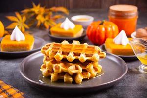 Autumn homemade pumpkin spice waffles with honey topping. photo