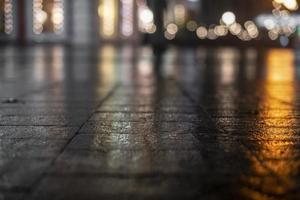 Night urban landscape, colored lights reflected in the wet asphalt in fall. Rainy night street in the city. The lights of a rainy night in the autumn city of disfocus and bokeh. Neon street. photo