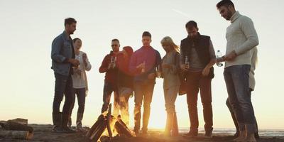 Friends having fun at beach on autumn day photo