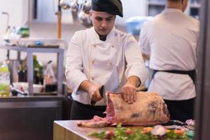 chef cutting big piece of beef photo