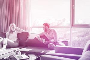 couple relaxing at  home using tablet computer photo