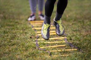 american football player exercises on ladder drills photo