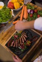 top view of Chef finishing steak meat plate photo