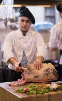 chef cutting big piece of beef photo