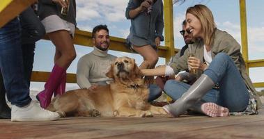 Group of friends having fun on autumn day at beach photo