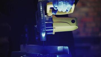 Worker Carpenter Sawing a Board with a Circular End Saw in his Carpentry Workshop. Woodworking Production. High quality 4k footage video