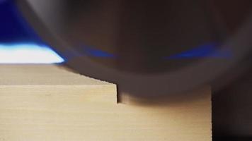 Worker Carpenter Sawing a Board with a Circular End Saw in his Carpentry Workshop. Woodworking Production. Macro shooting. Close up. video