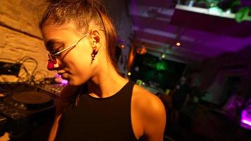 Woman in sunglasses dances in a club party