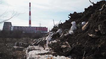 Big piles of garbage. Empty bottles, plastic in the waste dump. ecological disaster. environmental pollution. On the background of industrial pipes video