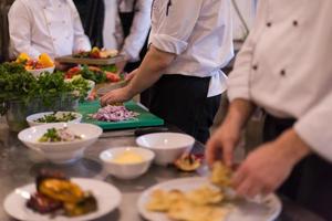 team cooks and chefs preparing meal photo