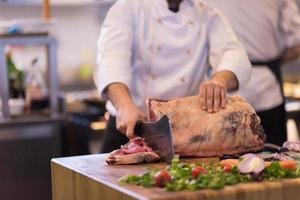 chef cutting big piece of beef photo