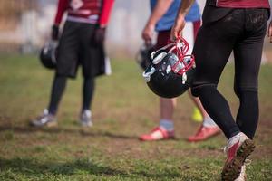 American football player holding helmet photo