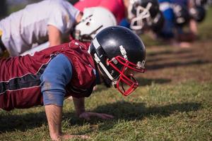 american football team doing push ups photo