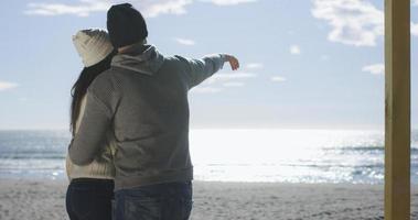 Couple having fun on beautiful autumn day at beach photo