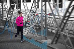 Woman running across the bridge photo