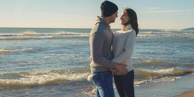 Couple having fun on beautiful autumn day at beach photo