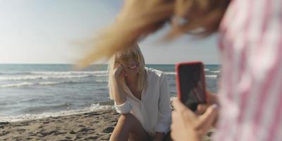 Two girl friends having fun photographing each other on vecation photo