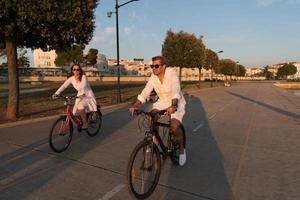 Senior couple enjoying a beautiful morning together riding a bike. Selective focus photo