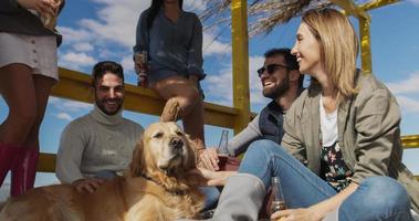 Group of friends having fun on autumn day at beach photo