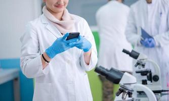 woman scientist using smartphone photo