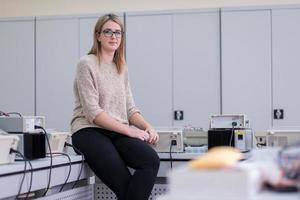 female student sitting on the table photo