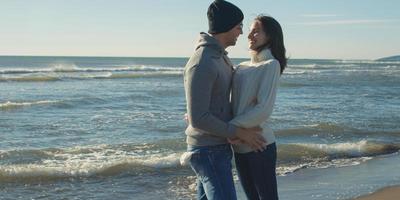 Couple having fun on beautiful autumn day at beach photo