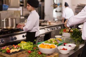 equipo de cocineros y chefs preparando comida foto