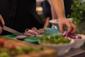 Chef  hands cutting the onion with knife photo