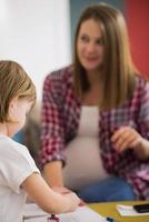 daughter painting nails to her pregnant mom photo