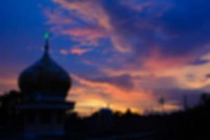 Blurred view of the mosque dome in the evening with violet sky. Blurred background. photo