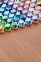 A pattern from a many nozzles from a paint sprayer for drawing graffiti, smeared into different colors. The plastic caps are arranged in many rows forming the color of the rainbow photo