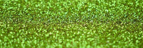 Lime green decorative sequins. Background image with shiny bokeh lights from small elements photo