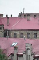 Fragment of a metal roof of the restored old multi-storey building in Lviv, Ukraine photo