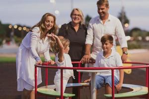 An elderly couple in casual clothes with their children and grandmother spend time together in the park on vacation. Family time. Selective focus photo