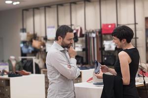 couple chooses shoes At Shoe Store photo