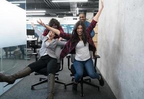 multiethnics business team racing on office chairs photo