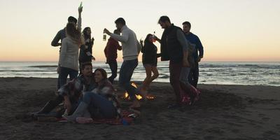 Friends having fun at beach on autumn day photo