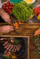 top view of Chef hands preparing beef steak photo