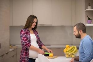 couple cooking food fruit lemon juice at kitchen photo