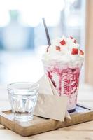 Strawberry smoothie on the table with blank card soft focus point photo