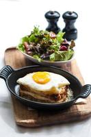Breakfast menu with beautiful fried eggs, bread and ham photo