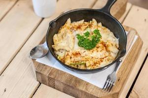 Cheesy baked macaroni and cheese pasta portion with parmesan sprinkled on top photo