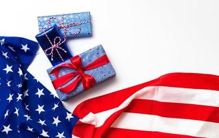 Happy Veterans Day concept. American flags with gift box against a blackboard background. November 11. photo