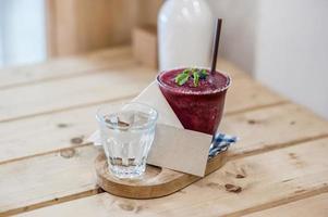 Blueberry smoothie on the table and blank card soft focus point photo