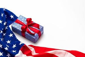 Happy Veterans Day concept. American flags with gift box against a blackboard background. November 11. photo